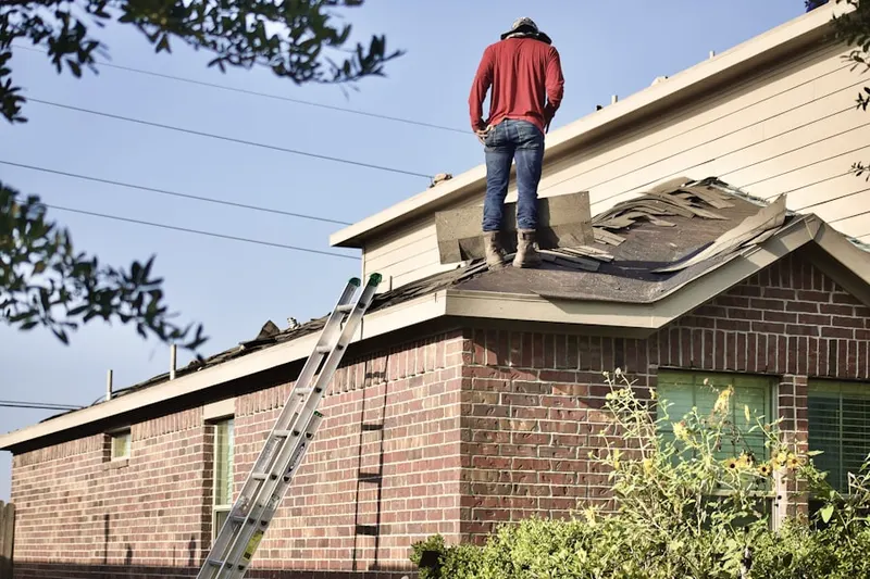Professional roofer working on a residential roof in Merced